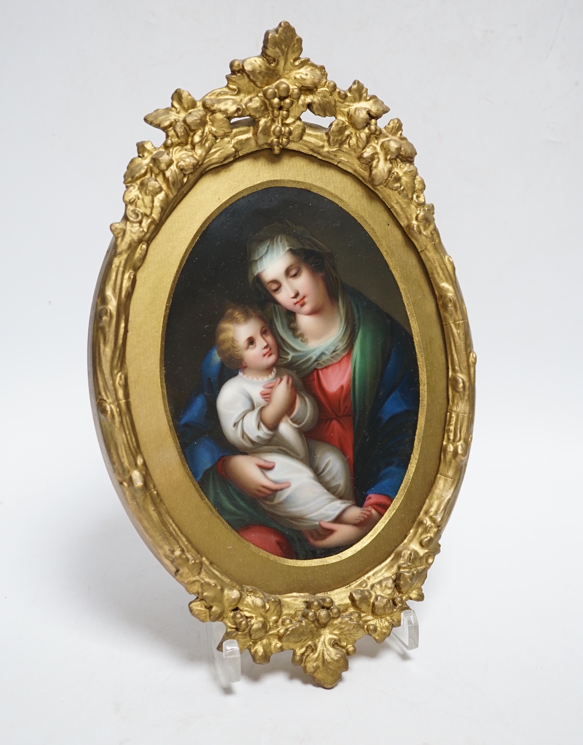 A 19th century Paris porcelain plaque depicting the Virgin Mother and child in a gilt painted frame, 16cm high